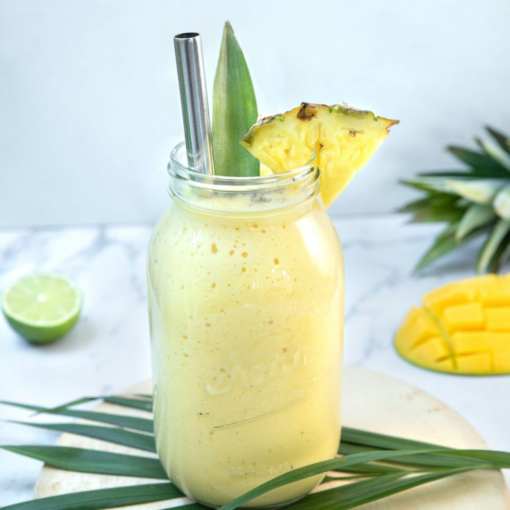 A tropical yellow smoothie with a chunk of pineapple